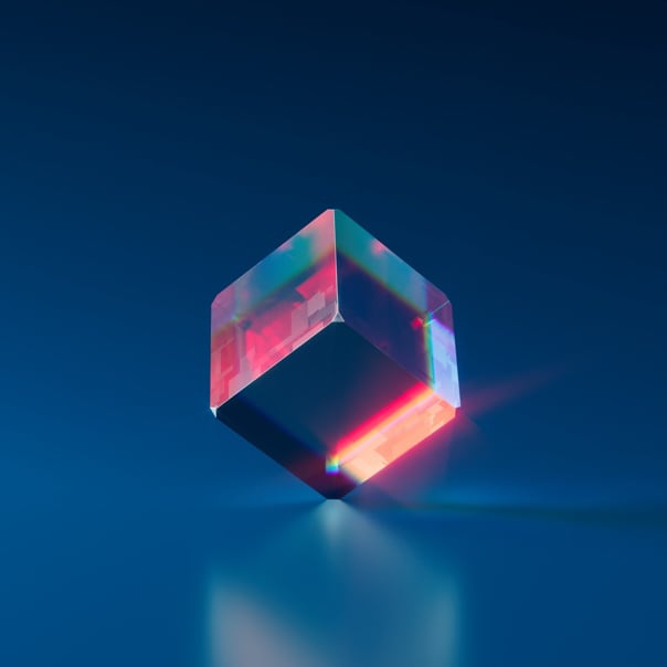 A cube balanced on its vertex.